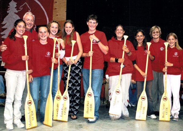 Group of camp counselors holding paddles