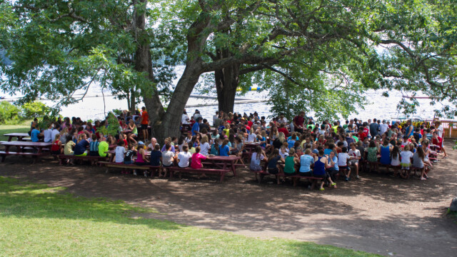 Campers sitting at picnic tables