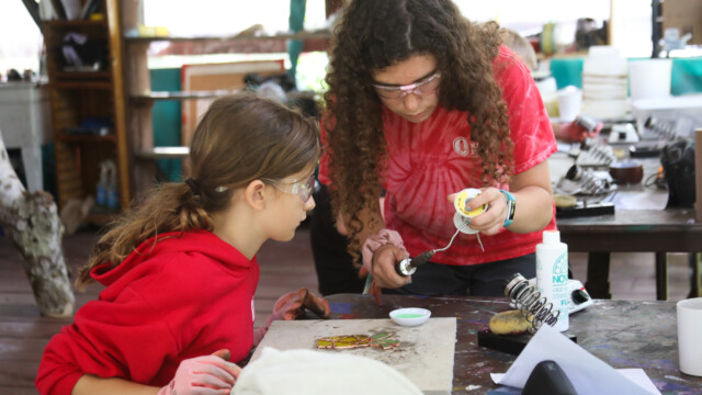 Counselor and camper making stained glass